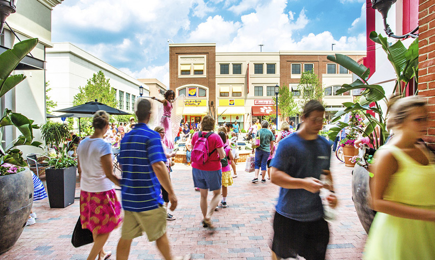People walking around Fenlon Square shopping center