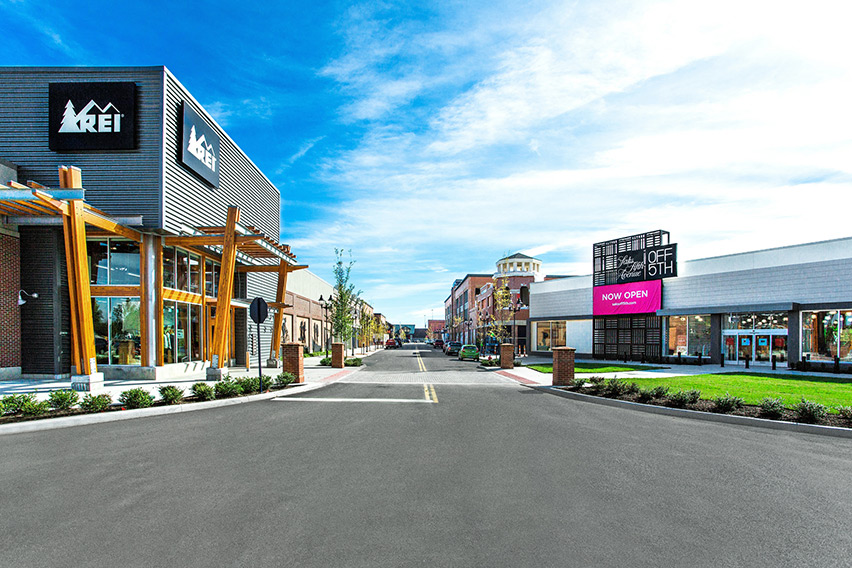 Looking down a street with an REI store and Saks Fifth Avenue