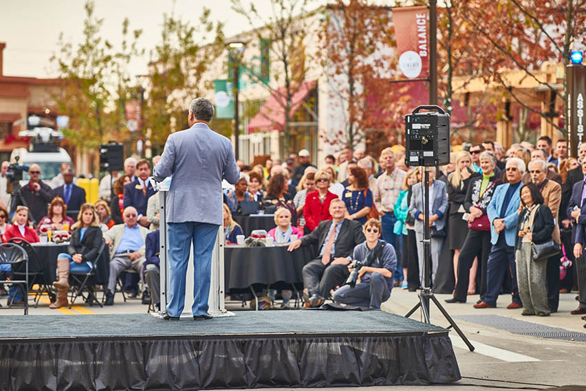 Yaromir Steiner speaking to a crowd from a stage at Liberty Center