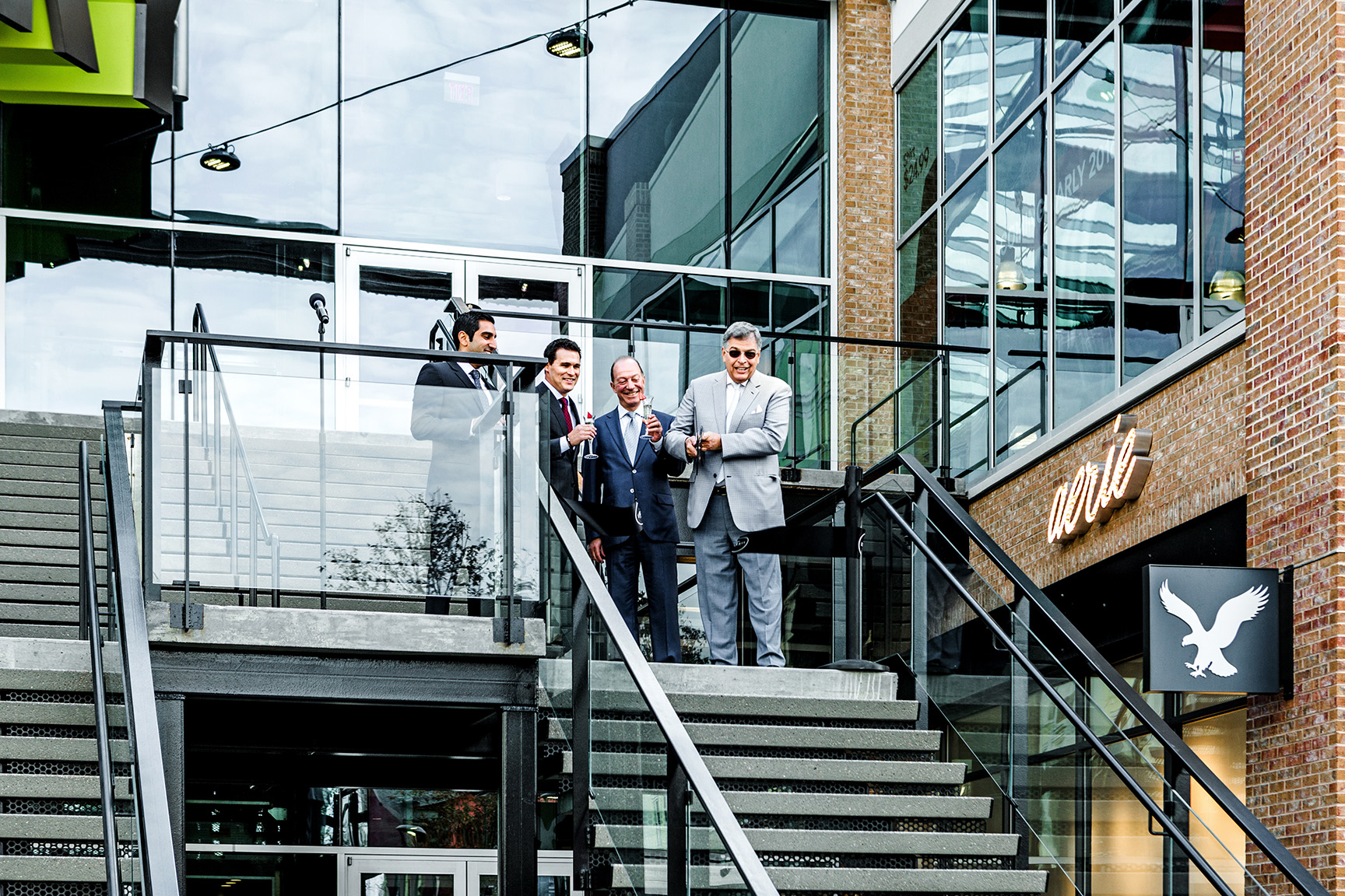 Yaromir Steiner cutting a ribbon at the top of stairs to open Liberty Center