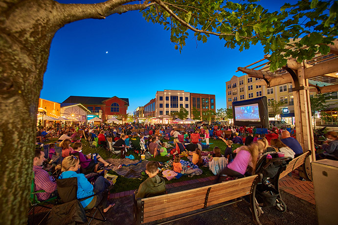 People watching an outdoor movie from the lawn