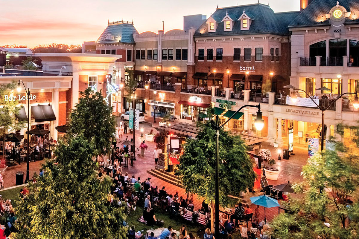 View of people sitting on the lawn at Legacy Village