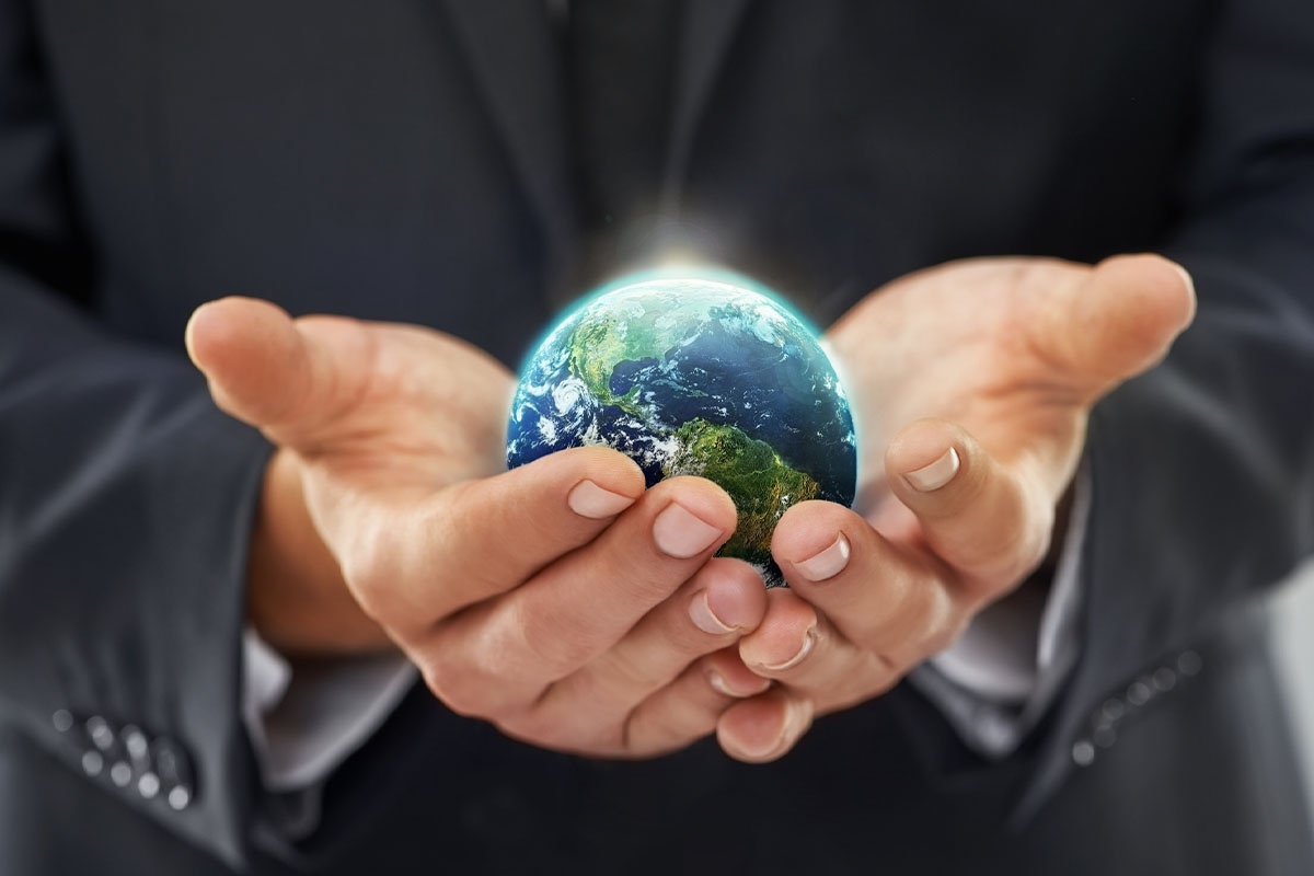 Hands holding a small globe