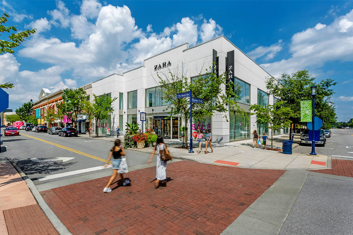 Shoppers walking by the Zara storefront
